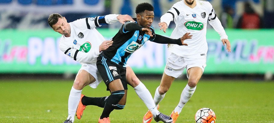 (L-R) Matthias Jouan of Granville, Georges-Kevin Nkoudou of Marseille and Antoine Peron of Granville during the French Cup game between US Granville V Olympique de Marseille at Stade Michel D'Ornano on March 3, 2016 in Caen, France.